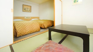 Una habitación con cama, una mesa y un cuadro colgado en la pared.