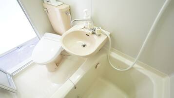 Een badkamer met toilet, wastafel en bad.