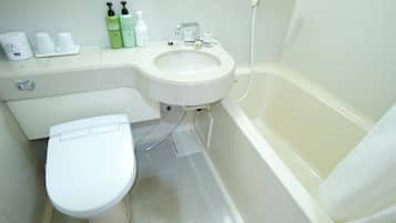 A bathroom with a toilet, sink, and bathtub.