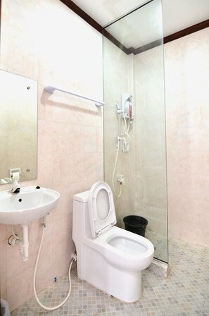 A bathroom with a toilet, sink, and shower. - Highway to H Inn - Danao (Danao)