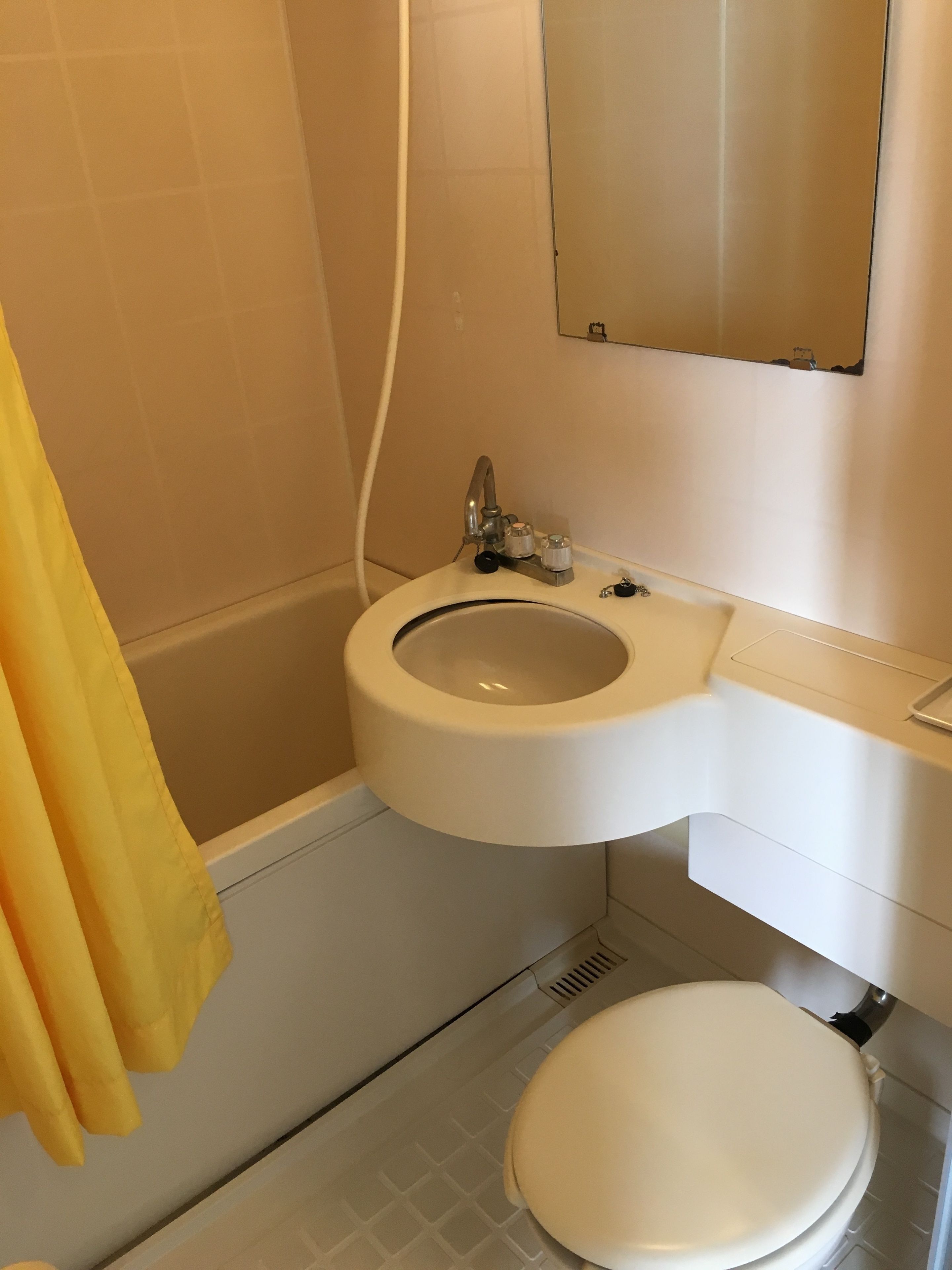 A bathroom with a toilet, sink, and bathtub.