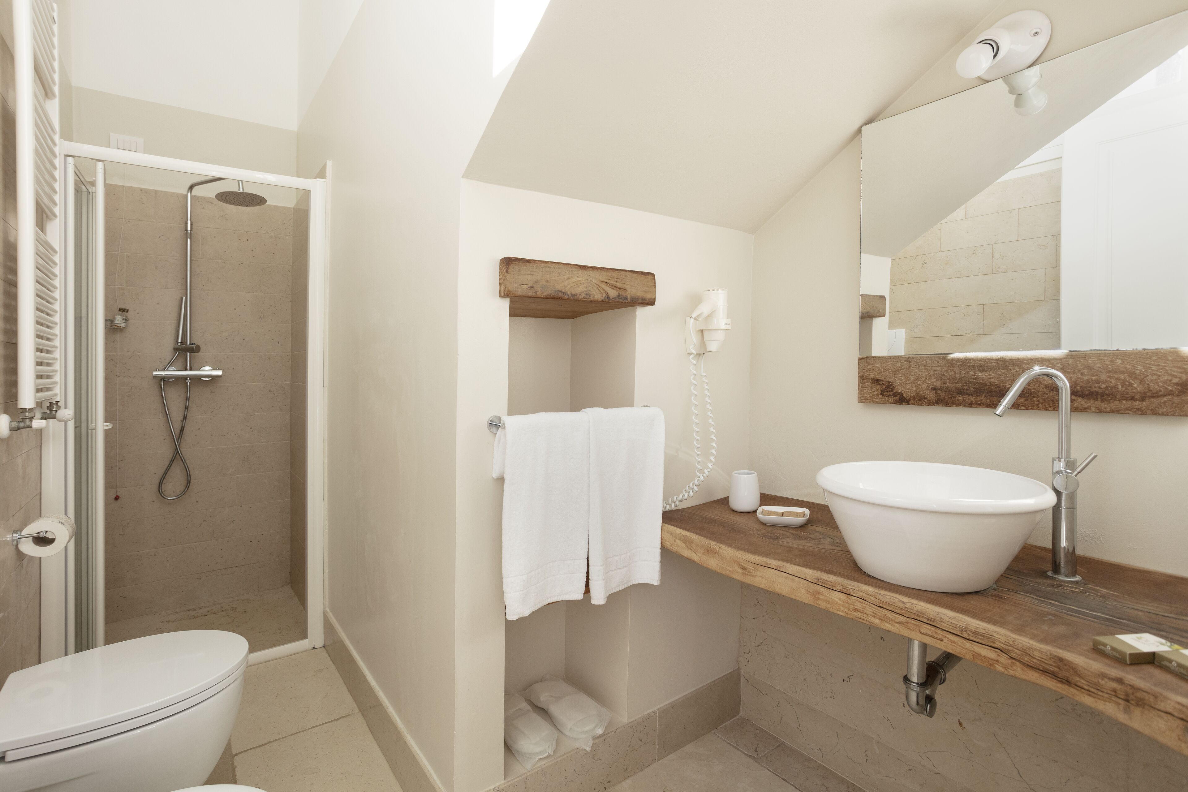 A modern bathroom with a shower, toilet, and sink.