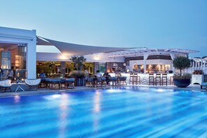 A poolside area with outdoor seating and a bar area.