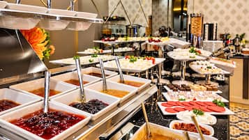 Un bufé con diferentes alimentos y salsas.