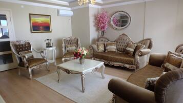 Deluxe Apartment, 3 Bedrooms | Living room | LCD TV