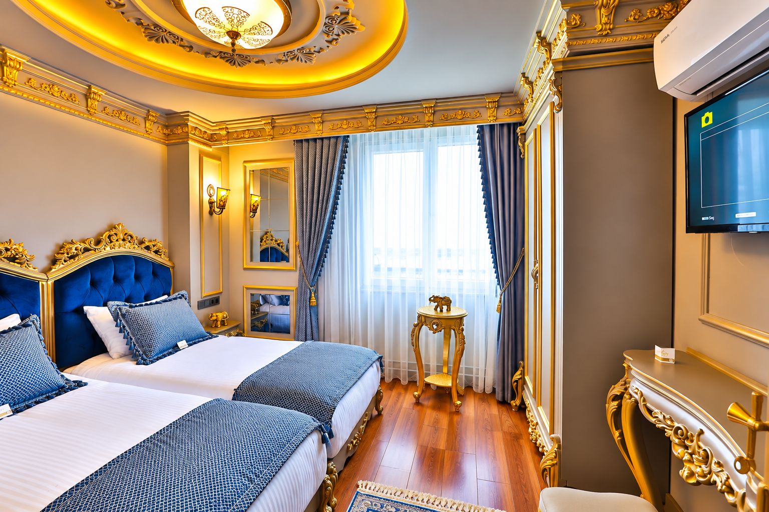A luxurious hotel room with a large bed, a television, and a decorative ceiling.