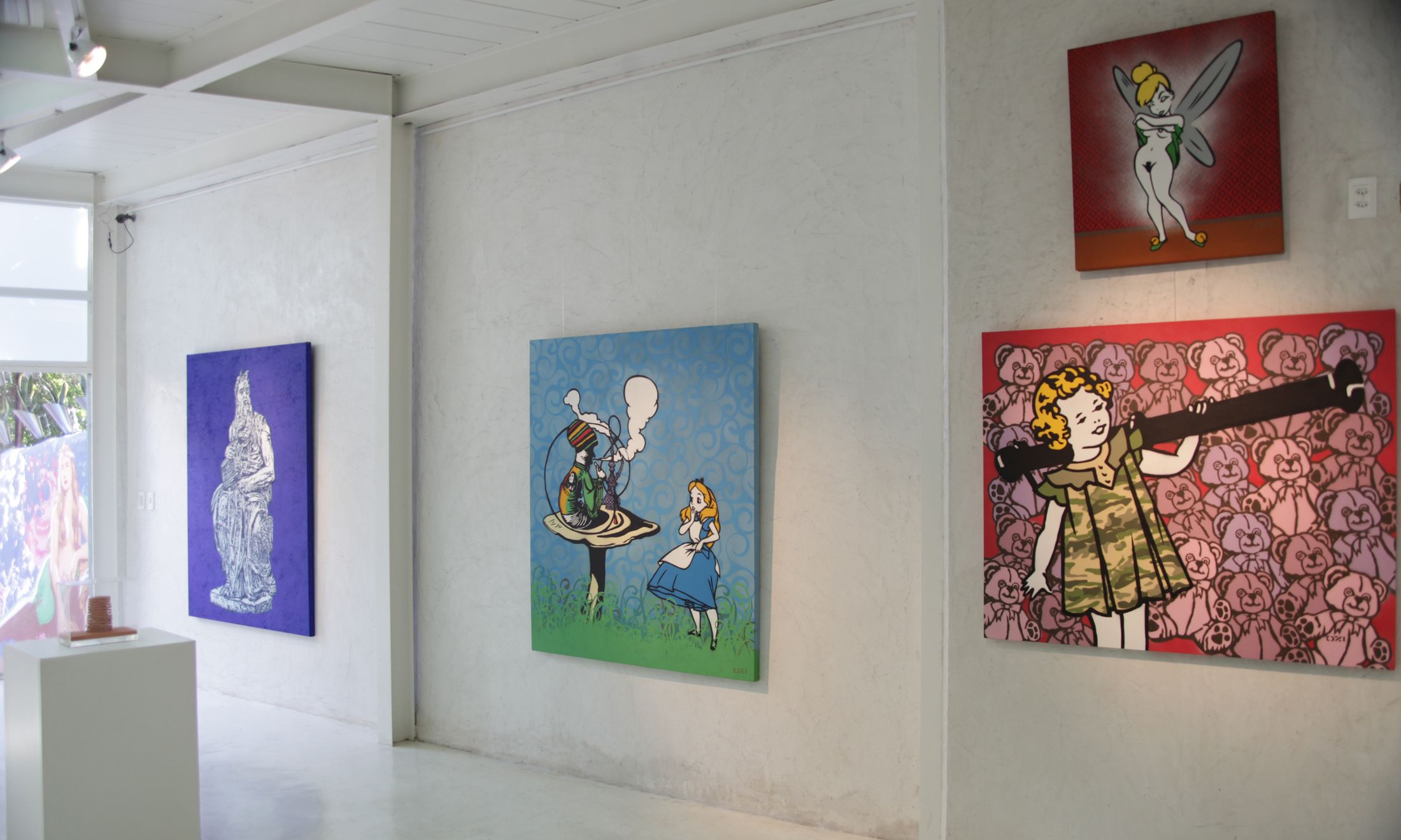 A gallery with three artworks on display.