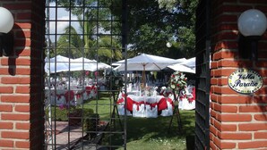 An outdoor wedding venue with tables and chairs, white and red decorations, and a sign reading "Villa Paraíso". - Villa Paraiso (Emiliano Zapata)