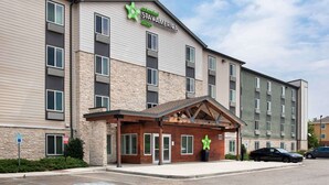 A multi-story hotel with a sign for Extended Stay America Suites.