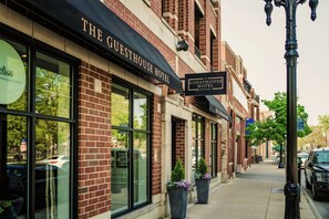 A brick building with large windows and a sign reading "The Guesthouse Hotel." - The Guesthouse Hotel (Chicago)