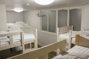 A room with bunk beds, a window with frosted glass, and a door with a handle. - Orange Guesthouse - Hostel (Busan)