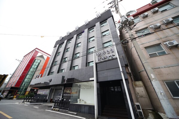 A multi-story building with a modern facade, large windows, and a visible entrance.