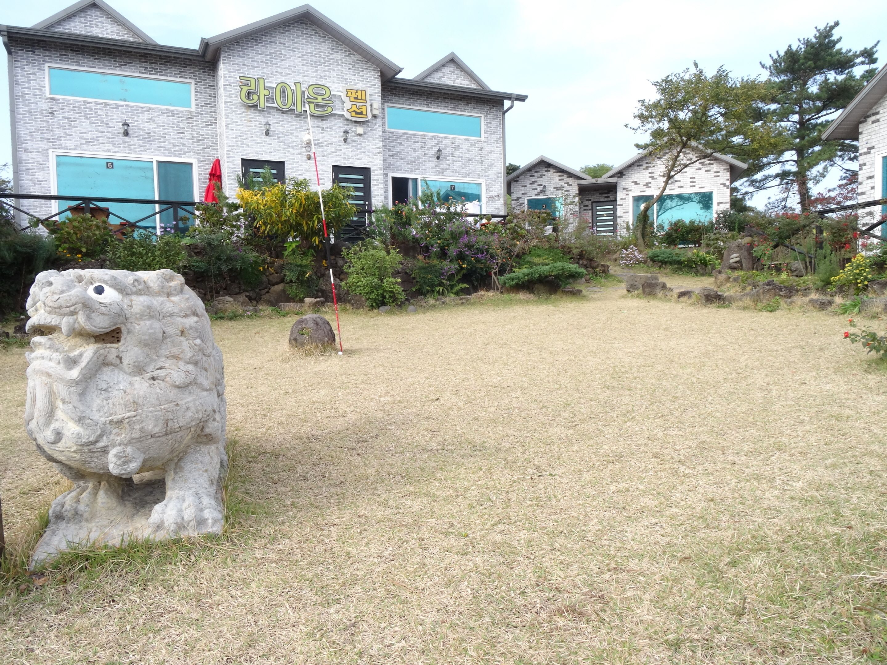 A building with a stone lion statue in front.