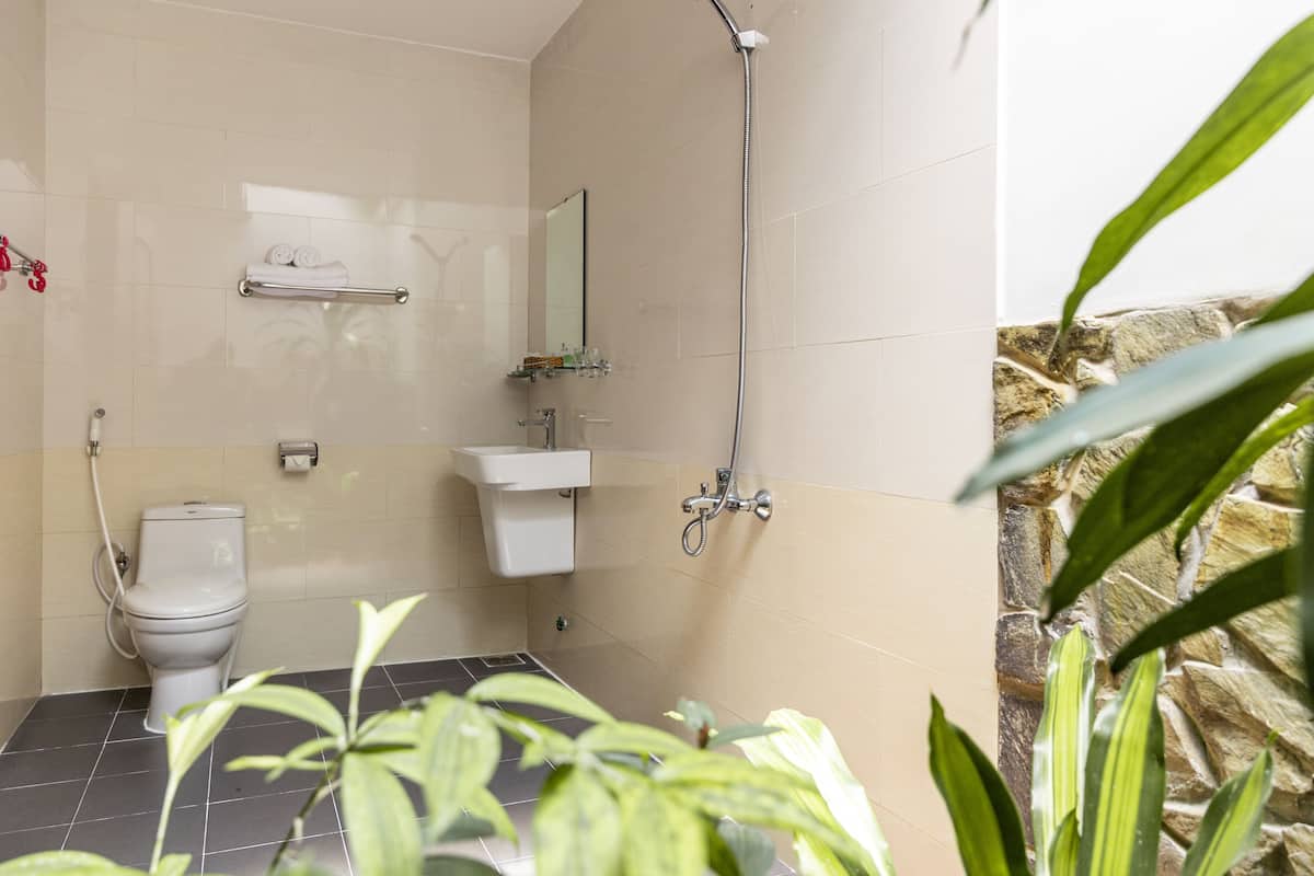 deluxe room, pool view | bathroom | shower, free toiletries, hair dryer, slippers