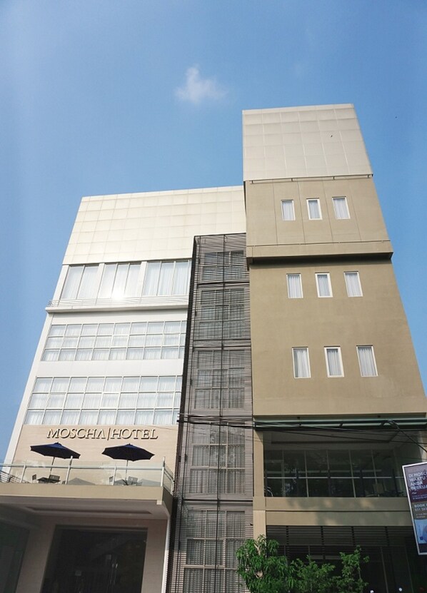 A hotel with a modern design, featuring a prominent 'MOSCHA HOTEL' sign, large windows, and a glass facade. - Moscha Hotel Surabaya (Surabaya)