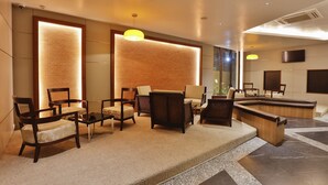 A modern lobby with seating areas, a reception desk, and a large window providing natural light. - The Link 83 Mandalay Boutique Hotel (Mandalay)