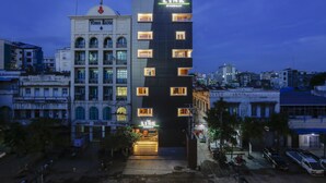 A multi-story building with a prominent 'Yoma Bank' sign and a 'The Link' sign on the side. - The Link 83 Mandalay Boutique Hotel (Mandalay)