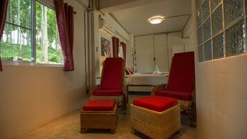 Relax in a serene forest view room with a comfortable seating area and a well-appointed bed.