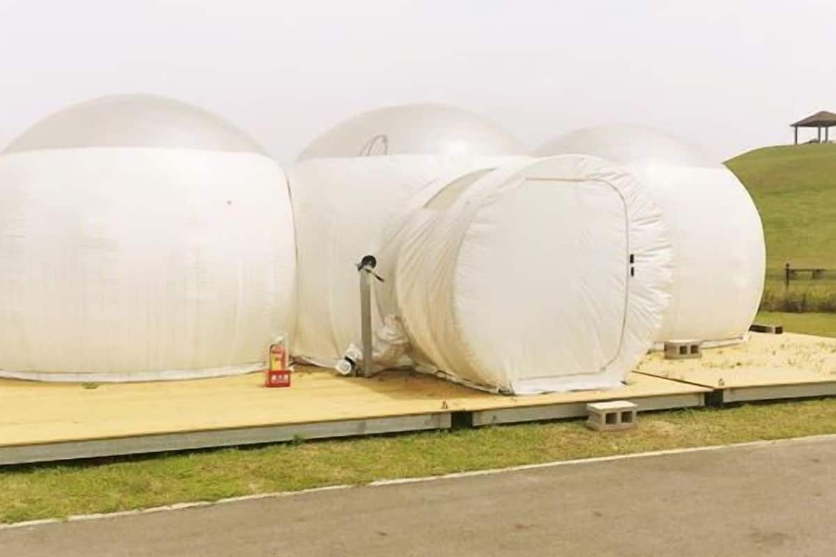 Large transparent domes on a flat platform.