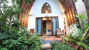 A villa with a wooden exterior, a stone staircase leading to a wooden door, and a sign above the door reading "Villa Calimene". - Green Bird Villa (Ubud)