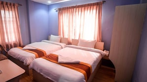 A hotel room with two beds, a wooden floor, a desk, and a telephone. - Hotel Shivam Plaza (Kathmandu)