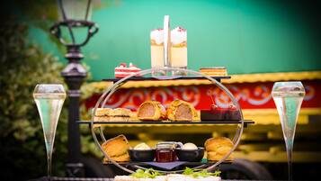 A tiered dessert display with various pastries and a selection of drinks.