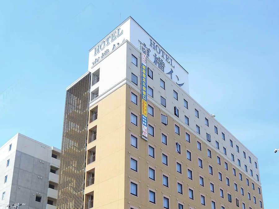A multi-story hotel building with a prominent "HOTEL" sign on the top.