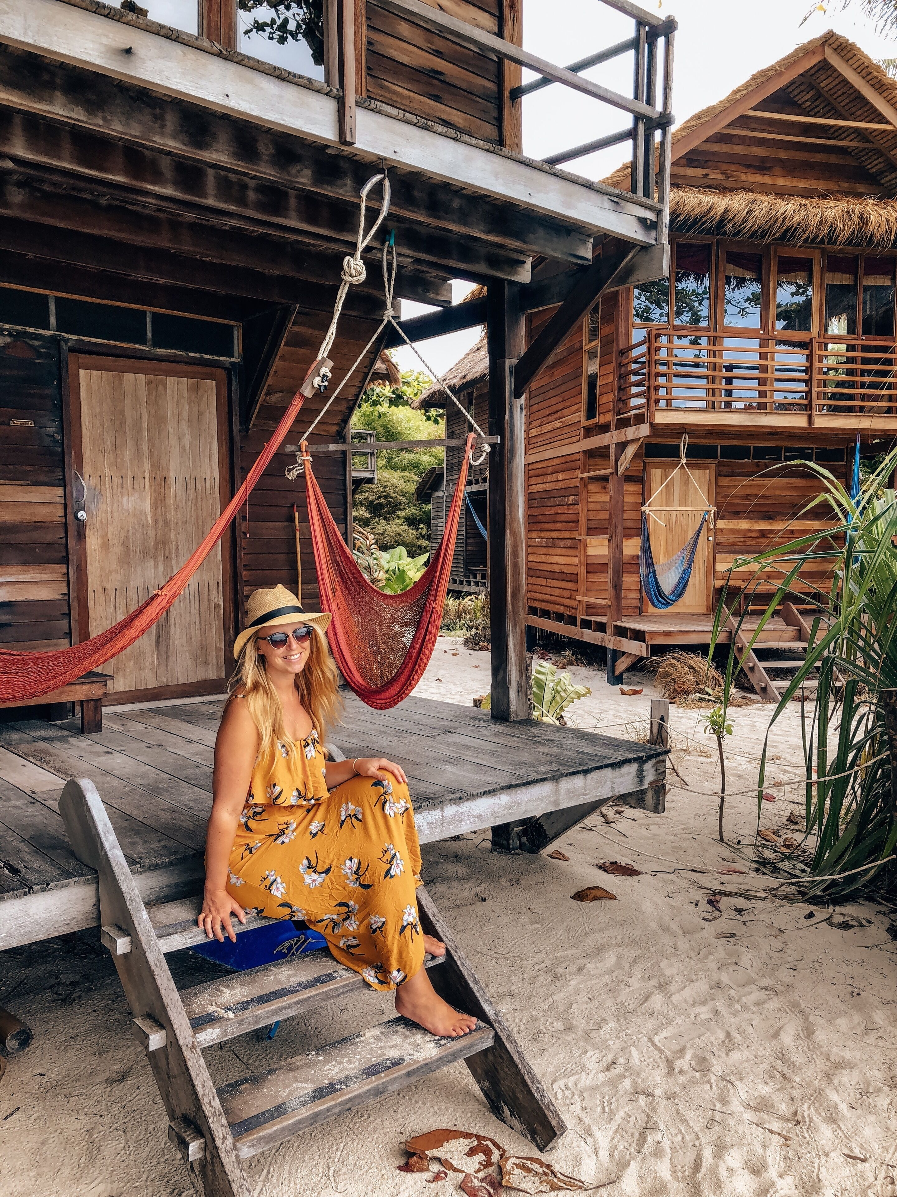 A wooden building with a balcony and a hammock.
