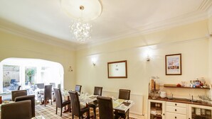 A dining area with a checkered floor, a chandelier, and a buffet counter with various food items. - Lemonfield Hotel (Sunderland)