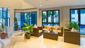 A modern lobby with wicker furniture, large windows, and potted plants. - Ava Sea Krabi Resort (Krabi)