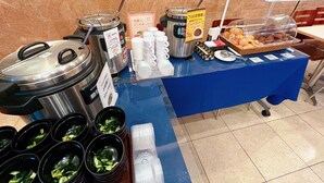 A buffet setup with various food items and serving utensils. - Toyoko Inn Hokkaido Sapporo Station Nishi Hokudai Mae (Sapporo)