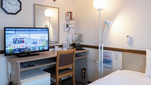 A hotel room with a desk, chair, bed, bedside table, lamp, clock, and a television displaying a train. - Toyoko Inn Hokkaido Sapporo Station Nishi Hokudai Mae (Sapporo)