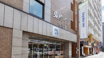 A building with a sign for 'Toyoko Inn' and another sign for 'Toyoko Inn Kyoto'.