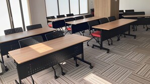 A conference room with multiple tables and chairs, large windows, and a herringbone-patterned floor. - Toyoko Inn Hokkaido Sapporo Station Nishi Hokudai Mae (Sapporo)