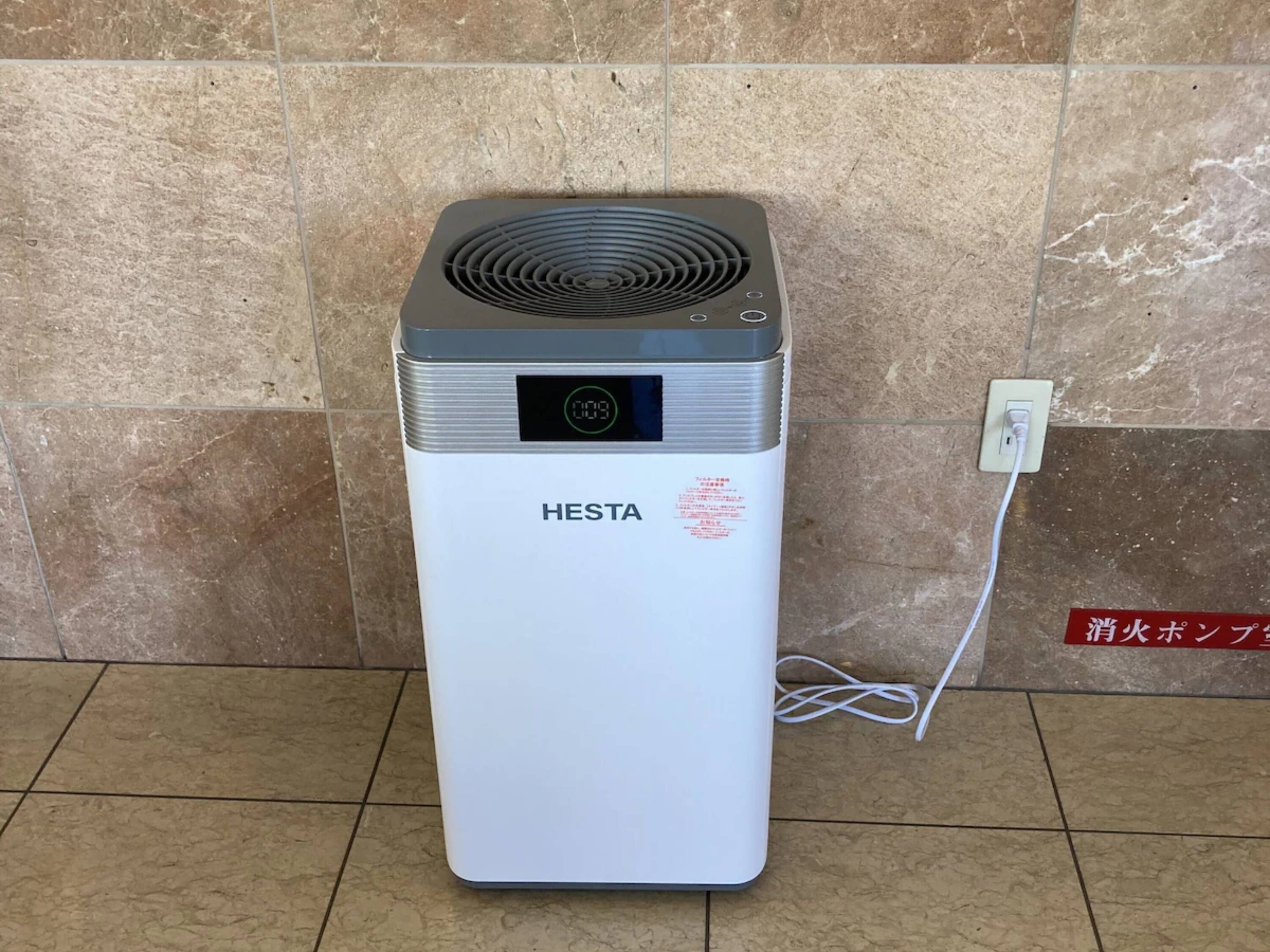 A white portable heater with a digital display and a brand name 'HESTA' on the front.