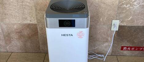 A white portable heater with a digital display and a brand name 'HESTA' on the front.