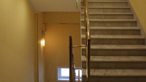 A staircase with a handrail leading to an upper floor.