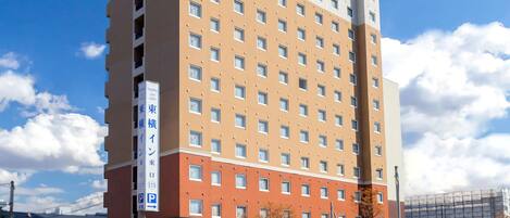 A multi-story hotel with a prominent sign indicating it is a Toyako Inn.