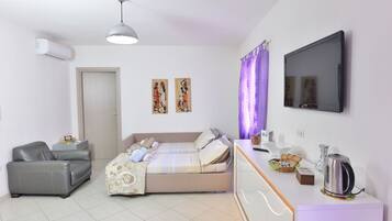 Apartment, 1 Bedroom | Living room | 43-inch flat-screen TV with digital channels, TV