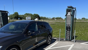 A parking area with a charging station for electric vehicles.