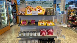 A display of scented candles and gift boxes in a store.