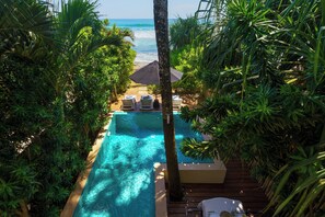 A pool with lounge chairs and a view of the ocean. - Chillax Villas (Matara)