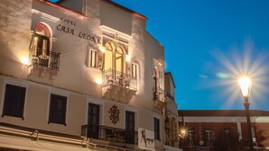 A building with the sign "Hotel Casa Leone" and a "Bookstore" sign below it.