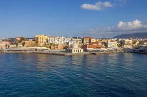 A coastal town with historic buildings, a waterfront promenade, and a prominent dome structure.