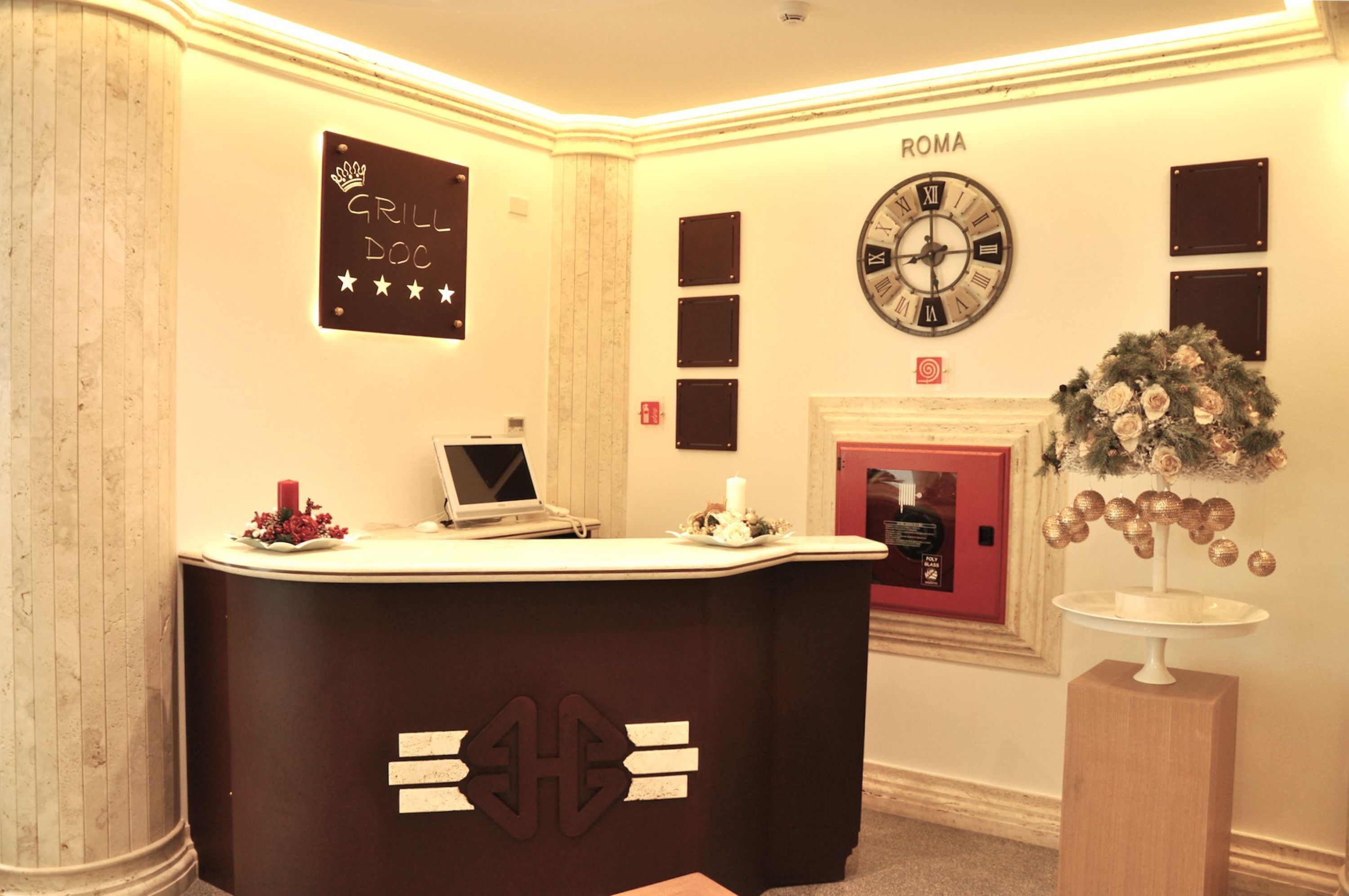 A reception desk with a sign reading "GRILL DOC" and a clock above it.