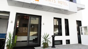 A modern hotel entrance with a sign reading "SMARTS HOTEL Welcome home." - Smarts Hotel (Rabat)