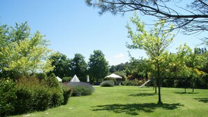 A well-maintained garden with a grassy lawn, a playground, and a gazebo. - Holiday Home in Montone with Pool & Garden (Montone)