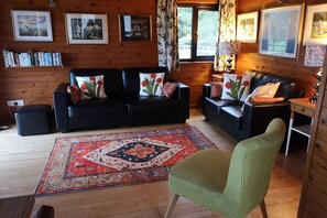 Relax in this inviting living room with two sofas, a statement rug, and framed artwork.