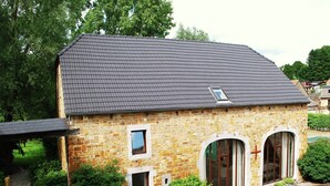A stone building with a sloped roof, a small window, and a door. - Luxury Holiday Haven in Sprimont (Sprimont)