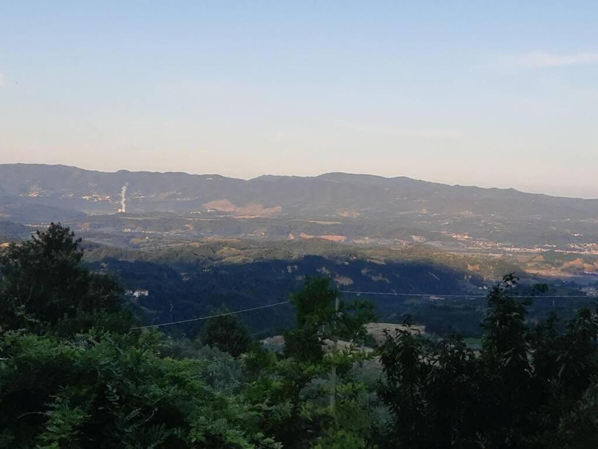 A panoramic view of a mountainous landscape with a clear sky.